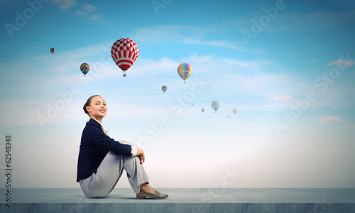 Photo: Businesswoman on roof Businesswoman on roof