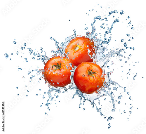 Photo: Tomato in spray of water. Tomato in spray of water.