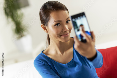 Photo: asian girl sharing pictureon social network asian girl sharing pictureon social network