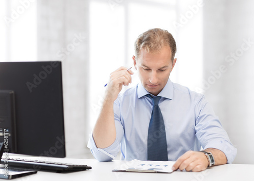 Photo: businessman writing in notebook businessman writing in notebook