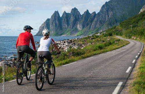 Photo: two cyclists relax biking two cyclists relax biking