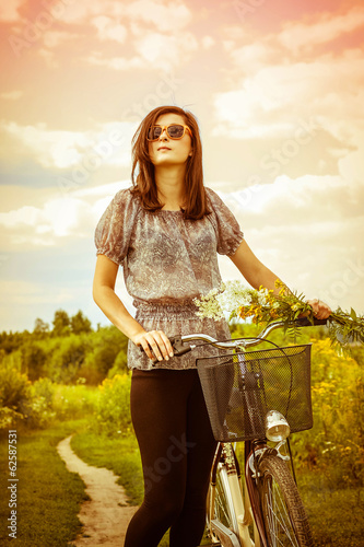 Photo: Beautiful young woman and a bike Beautiful young woman and a bike