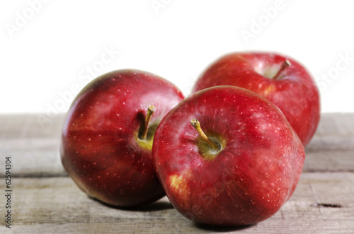 Photo: red apples on wooden table red apples on wooden table