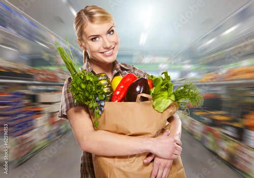 Photo: woman shopping for fruits and vegetables in produce department o woman shopping for fruits and vegetables in produce department o
