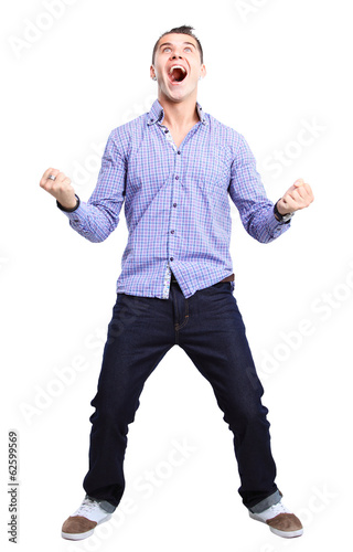 Photo: Excited handsome man with arms raised in success Excited handsome man with arms raised in success