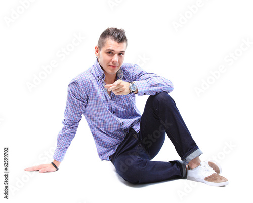 Photo: Flirtatious man sitting on the floor Flirtatious man sitting on the floor