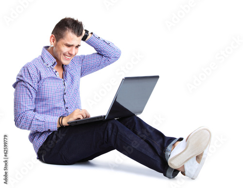 Photo: happy man working on laptop in casuals happy man working on laptop in casuals