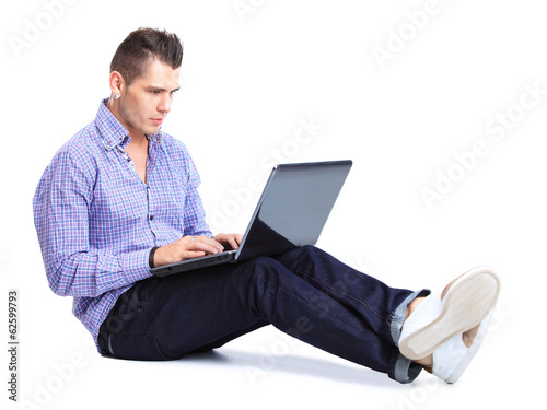 Photo: happy man working on laptop in casuals. Concept communication. happy man working on laptop in casuals. Concept communication.