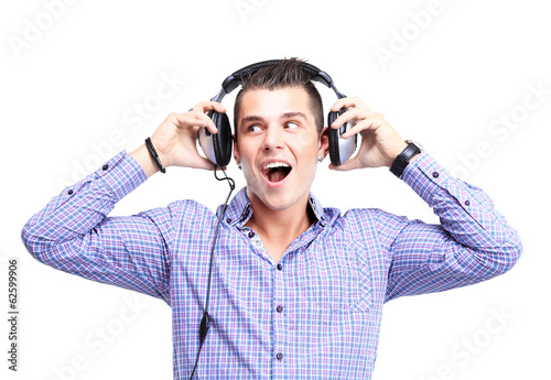 Photo: Attractive young man wearing headphones on white background Attractive young man wearing headphones on white background