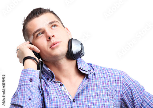 Photo: Attractive young man wearing headphones on white background Attractive young man wearing headphones on white background