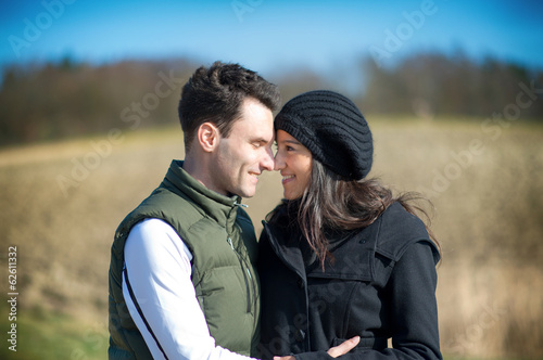 Photo: Happy love couple hugging each other outside in spring season Happy love couple hugging each other outside in spring season