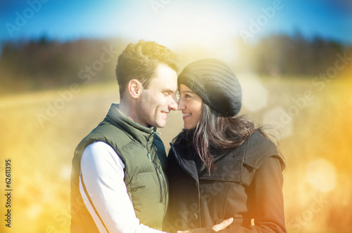 Photo: Happy love couple hugging each other outside in spring season Happy love couple hugging each other outside in spring season