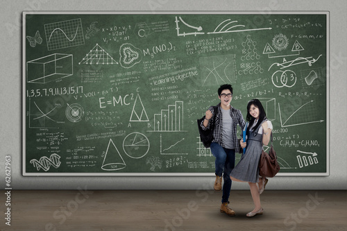 Photo: Happy students expressing success at class Happy students expressing success at class