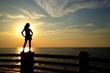 silhouette of woman standing at the sea silhouette of woman standing at the sea