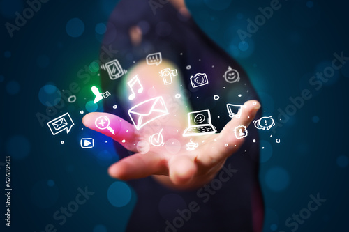 Photo: Young woman presenting colorful social media icons Young woman presenting colorful social media icons