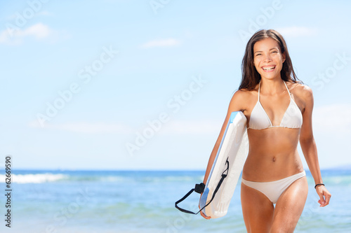 Photo: Woman surfer girl on beach Woman surfer girl on beach