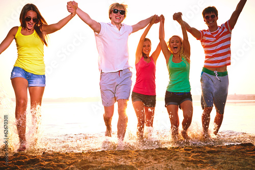 Photo: Group of happy teenagers at the beach Group of happy teenagers at the beach