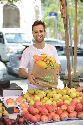 Photo: Small business owner selling organic fruits and vegetables. Small business owner selling organic fruits and vegetables.