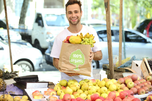 Photo: Small business owner selling organic fruits and vegetables. Small business owner selling organic fruits and vegetables.