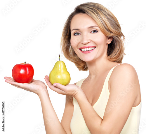 Photo: Young beautiful happy woman holds the apple and pear. Young beautiful happy woman holds the apple and pear.