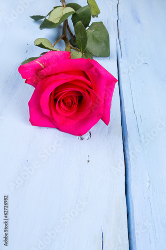 Photo: beautiful rose on wooden surface beautiful rose on wooden surface