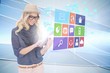 Stylish blonde using tablet pc with app icon menu Stylish blonde using tablet pc with app icon menu