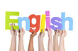 Multi-Ethnic Group of Hands Holding The Word English Multi-Ethnic Group of Hands Holding The Word English