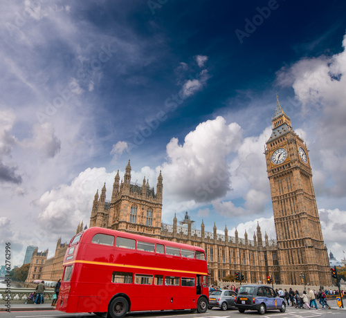 Photo: Red bus on Westminster Bridge under a dramatic sky - London Red bus on Westminster Bridge under a dramatic sky - London