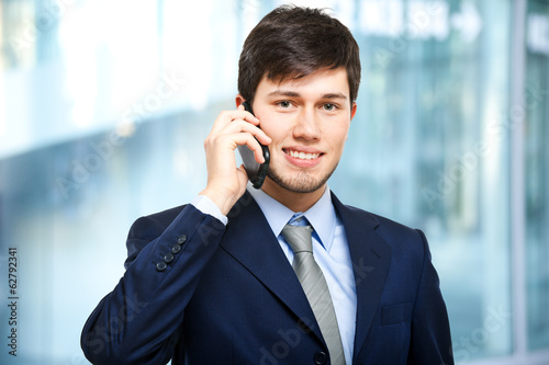 Photo: Young businessman talking at the phone Young businessman talking at the phone