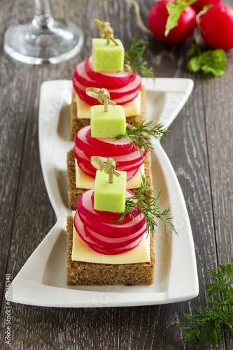 Photo: Appetizer of black bread with radish and cheese. Appetizer of black bread with radish and cheese.