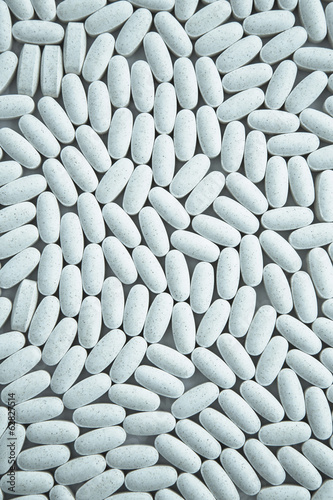 Photo: Vitamin C supplements, small blue oval tablets. Vitamin C supplements, small blue oval tablets.