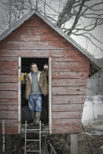 Photo: An organic farm in upstate New York, in winter. A man standing in the doorway of a henhouse. An organic farm in upstate New York, in winter. A man standing in the doorway of a henhouse.