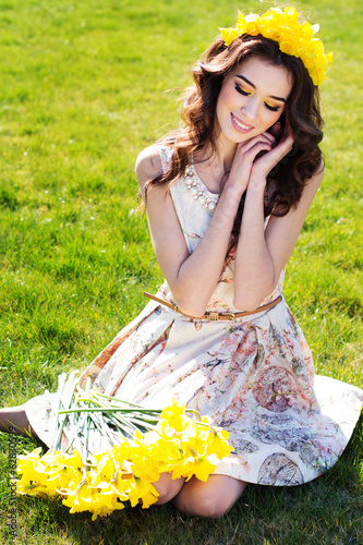 Photo: Happy smiling girl with yellow flowers Happy smiling girl with yellow flowers