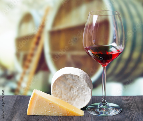 Photo: Glass of wine and cheese in winery Glass of wine and cheese in winery