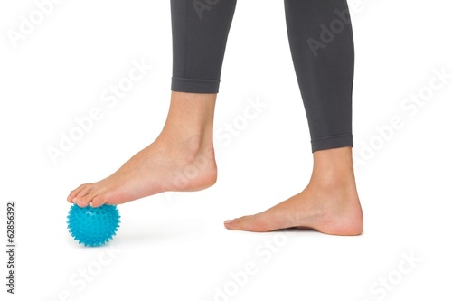 Photo: Close-up low section of woman standing over stress ball Close-up low section of woman standing over stress ball