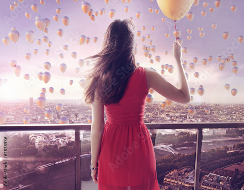 Photo: Young woman staring at thousands of the balloons Young woman staring at thousands of the balloons