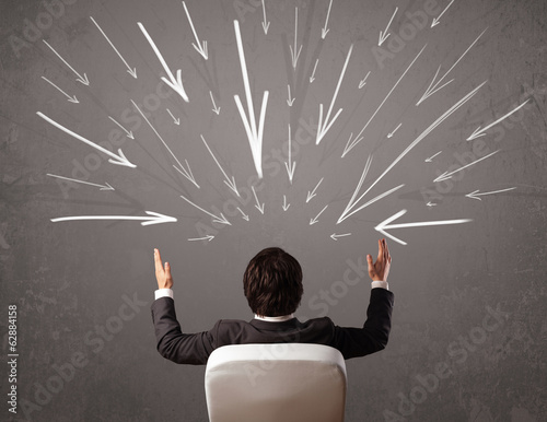Photo: Business man with hand drawn arrows pointing at his head Business man with hand drawn arrows pointing at his head