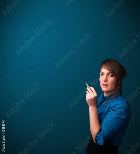 Photo: Beautiful woman smoking cigarette vith copy space Beautiful woman smoking cigarette vith copy space