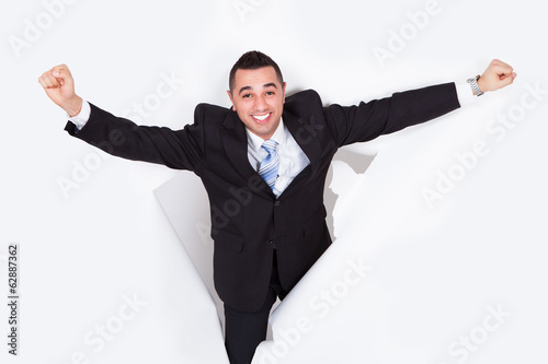 Photo: Successful Businessman Breaking Through White Wall Successful Businessman Breaking Through White Wall
