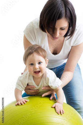 Photo: mother doing gymnastics with baby on fitness ball mother doing gymnastics with baby on fitness ball