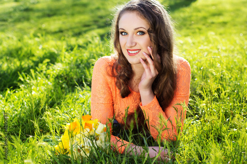 Photo: Happy smiling girl with yellow flowers Happy smiling girl with yellow flowers