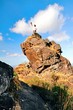 a man stand on top of the rock under blue sky a man stand on top of the rock under blue sky