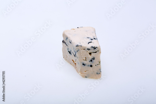 Photo: piece of blue cheese on white background piece of blue cheese on white background