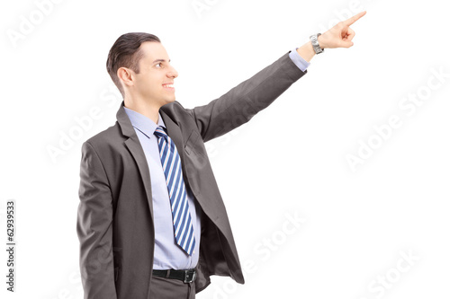 Photo: Businessman with briefcase pointing in a direction Businessman with briefcase pointing in a direction