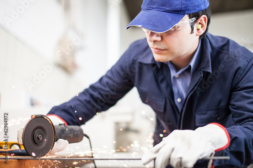 Photo: Worker using a grinder Worker using a grinder
