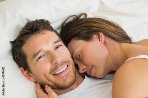 Photo: Close-up of a loving couple lying in bed Close-up of a loving couple lying in bed