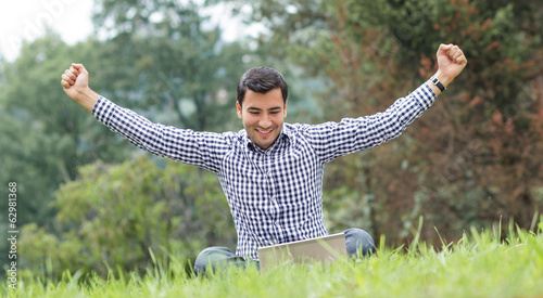 Photo: Successful online business man with laptop Successful online business man with laptop