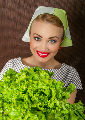 Photo: Happy smiling woman cook holding salad Happy smiling woman cook holding salad
