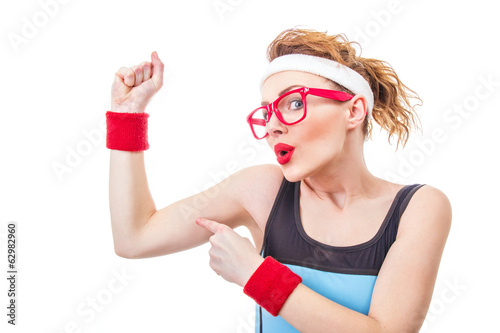 Photo: Funny fitness woman pointing on her biceps Funny fitness woman pointing on her biceps