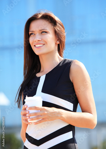 Photo: businesswoman professional walking outdoors drinking coffee businesswoman professional walking outdoors drinking coffee